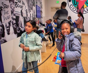 Kids check out the current exhibit at the CAAM. Photo by HRDWRKER