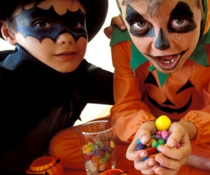 Got too much Halloween candy? We rounded up the best Halloween candy donation programs! Photo by Pixland via Canva