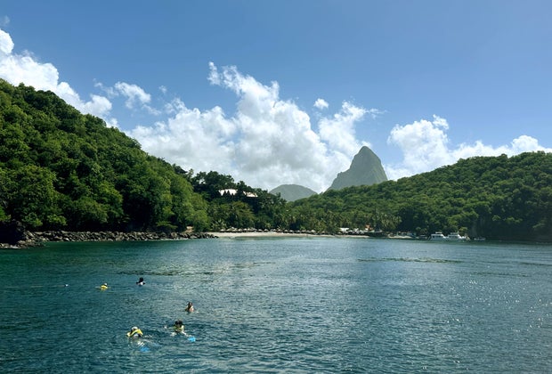 A gorgeous view of the Pitons from a boat that will take you snorkeling in Turtle Reef.