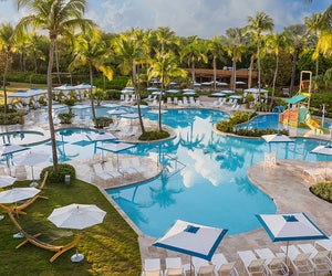 Splash into the lagoon-style swimming pool and doze off under a beach cabana at Wyndham Rio Mar. Golf & Beach Resort. Photo courtesy of the resort