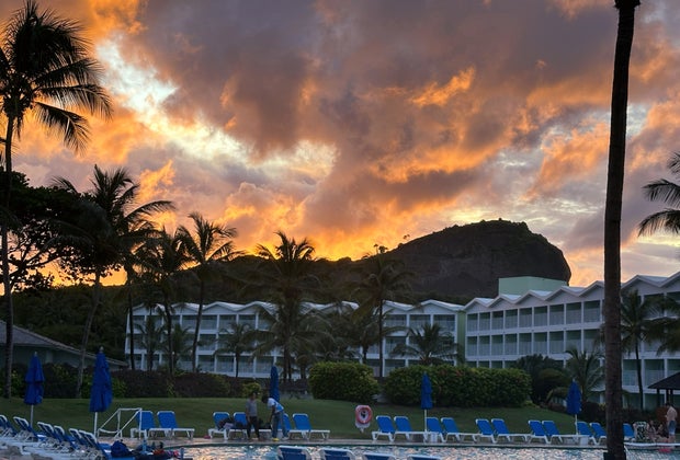 Sunset over a hill behind a hotel on the beach in St. Lucia.