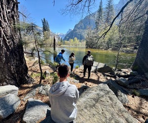 Take a break along the Merced River as you hike along the Valley Loop Trail in Yosemite National Park. 